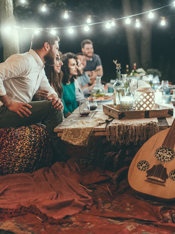 Friends gathered around a candlelit table