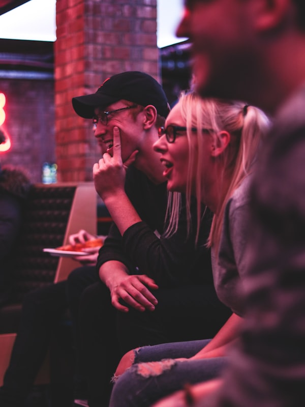 Friends laughing together on a sofa